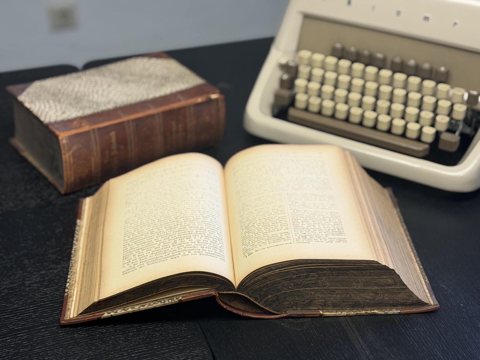 Juristische Bücher und Schreibmaschine auf einem Kanzleitisch